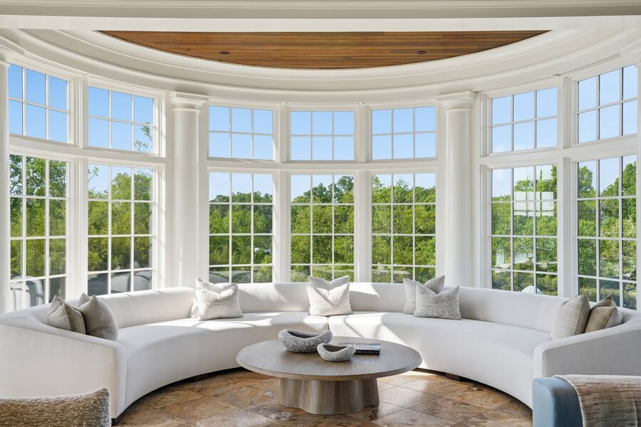Curved bay sunroom with walls of windows
