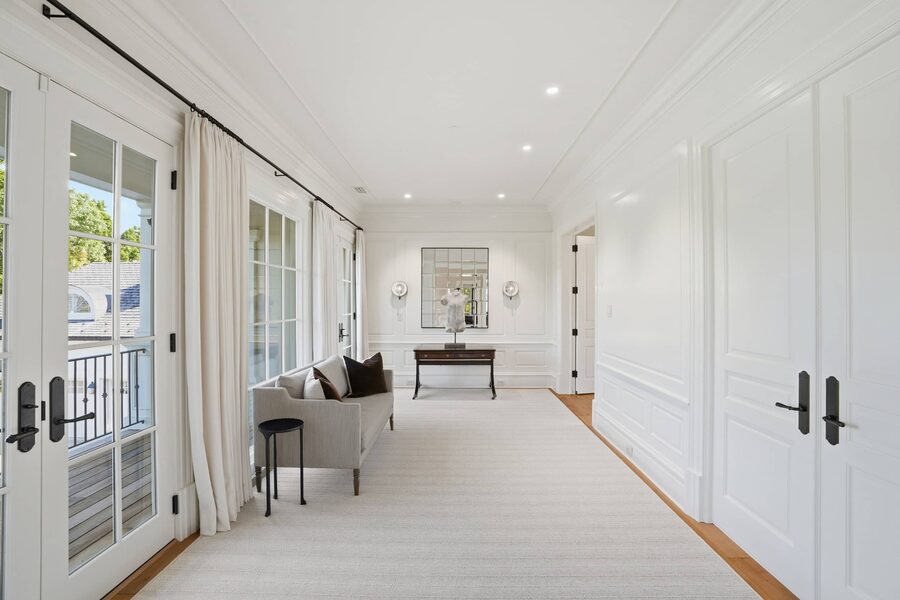 Long upper hall with wall sconces